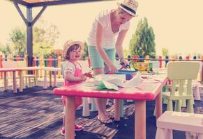 mom and little daughter drawing a colorful pictures photo