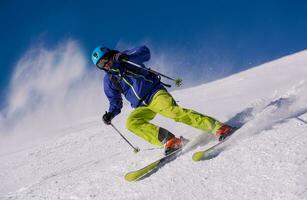 Skier having fun while running downhill photo