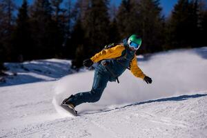 snowboarder running down the slope and ride free style photo