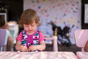 little girl drawing a colorful pictures photo