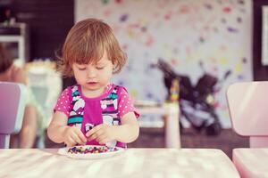 little girl drawing a colorful pictures photo