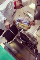 chef preparing food, frying in wok pan photo