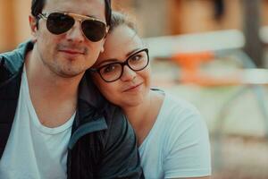 A romantic couple spending time in the park. A couple taking photo on a beautiful sunny day while having a weekend off