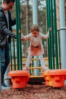 Family time in the park. Father have fun with his daughter in the park, playing fun games and spending time together photo