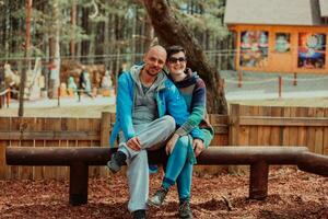 A romantic couple spending time in the park. A couple taking photo on a beautiful sunny day while having a weekend off