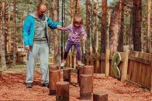 Family time in the park. Father have fun with his daughter in the park, playing fun games and spending time together photo