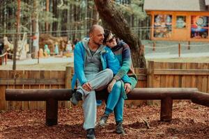 A romantic couple spending time in the park. A couple taking photo on a beautiful sunny day while having a weekend off