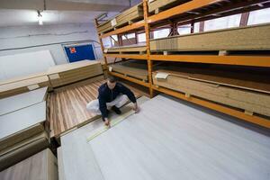 carpenter measuring wooden board photo