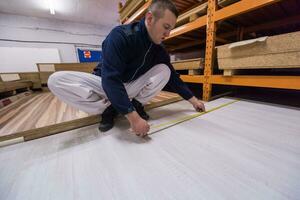 carpenter measuring wooden board photo