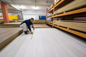 carpenter measuring wooden board photo