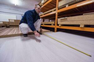 carpenter measuring wooden board photo