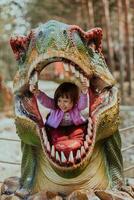 A little girl playing in the park. The concept of family socializing in the park. A girl swings on a swing, plays creative games photo