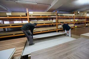 two young carpenters working in big modern carpentry photo