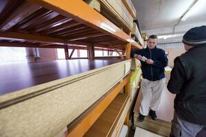 two young carpenters working in big modern carpentry photo