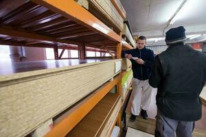 two young carpenters working in big modern carpentry photo