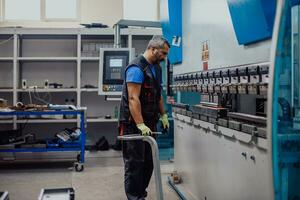 A smart factory worker or engineer makes machines in a production workshop. The concept of industry and engineering. Selective focus photo