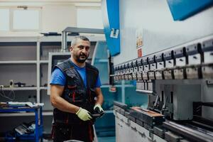 A smart factory worker or engineer makes machines in a production workshop. The concept of industry and engineering. Selective focus photo