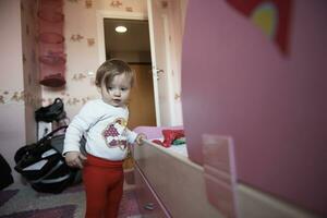 cute  little one year old baby and making first steps photo