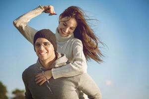 couple having fun at beach during autumn photo