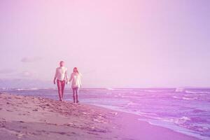 Loving young couple on a beach at autumn sunny day photo