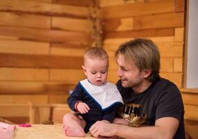 Portrait of young father and his cute baby son photo