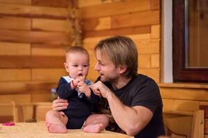 Portrait of young father and his cute baby son photo