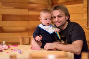 Portrait of young father and his cute baby son photo