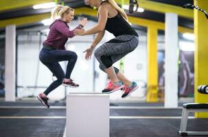 athletes working out  jumping on fit box photo
