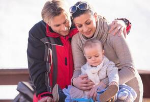 young happy family with little child enjoying winter day photo