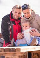young happy family with little child enjoying winter day photo