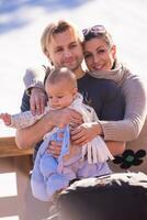 young happy family with little child enjoying winter day photo