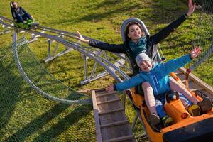 young mother and son driving alpine coaster photo