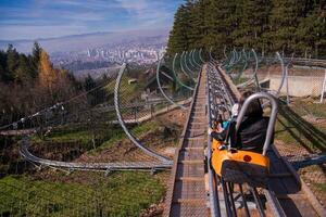 young mother and son driving alpine coaster photo