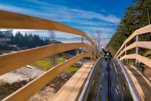 young father and son driving alpine coaster photo