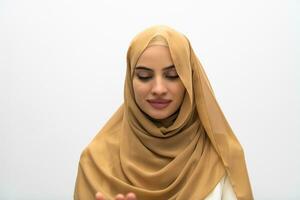 Portrait of young muslim woman wearing hijab on isolated white background photo