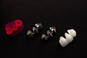 Teeth implant and crown installation process parts isolated on a black background. Medically accurate 3D model. photo