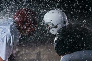 two american football players face to face in silhouette shadow on white background photo