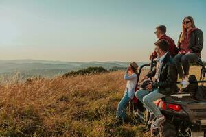 Group young happy people enjoying beautiful sunny day while driving a off road buggy car on mountain nature photo