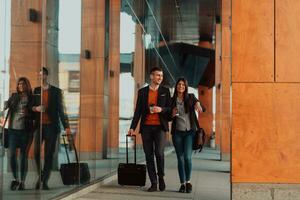 Two businessmen walk around town drinking coffee photo