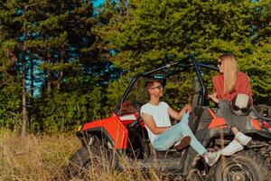 joven contento emocionado Pareja disfrutando hermosa soleado día mientras conducción un apagado la carretera calesa coche en montaña naturaleza foto