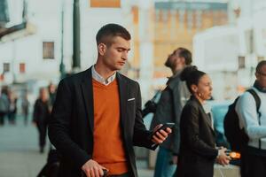 Going to airport terminal. Confident businessman traveler walking on city streets and pulling his suitcase drinking coffee and speaking on smartphone photo