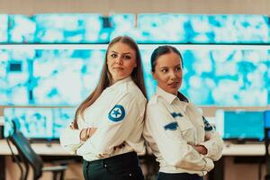 group portrait of female security operator while working in a data system control room offices Technical Operator Working at workstation with multiple displays, security guard working on multiple mon photo