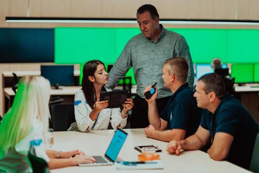 Group of security guards sitting and having briefing In the system control room They're working in security data center surrounded by multiple Screens photo