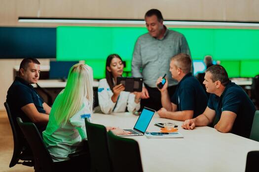 Group of security guards sitting and having briefing In the system control room They're working in security data center surrounded by multiple Screens photo