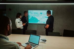 Group of Security data center operators working in a CCTV monitoring room looking on multiple monitors Officers Monitoring Multiple Screens for Suspicious Activities Team working on the System Contr photo