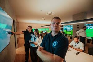 Group of Security data center operators working in a CCTV monitoring room looking on multiple monitors Officers Monitoring Multiple Screens for Suspicious Activities Team working on the System Contr photo