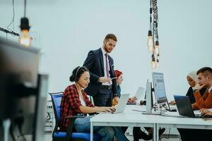 Multiethnic group of employees working in a marketing company. A group of colleagues is working on a project in modern offices photo