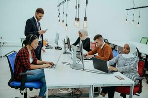 Multiethnic group of employees working in a marketing company. A group of colleagues is working on a project in modern offices photo