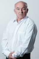 Senior grey-haired man wearing elegant shirt isolated on white background depressed and worry for distress, crying angry and afraid. Sad expression. photo