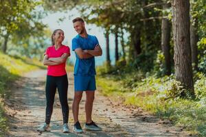 Couple enjoying in a healthy lifestyle while jogging on a country road photo